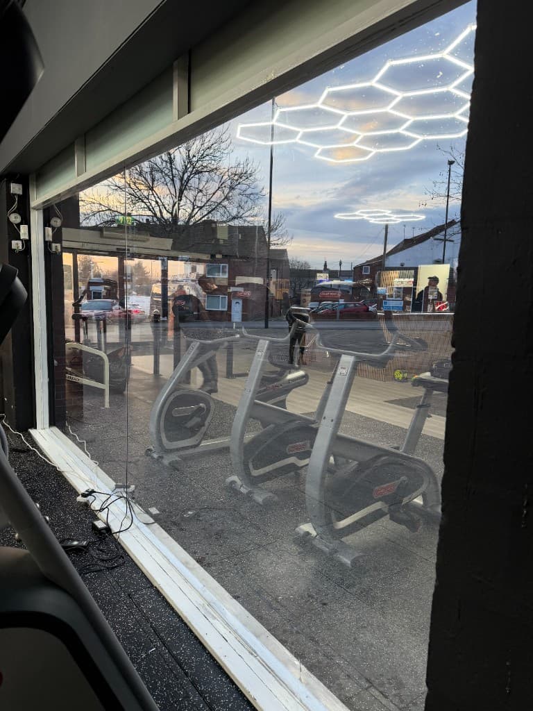Mirror window film Rotherham — gym window with hexagonal lights reflection