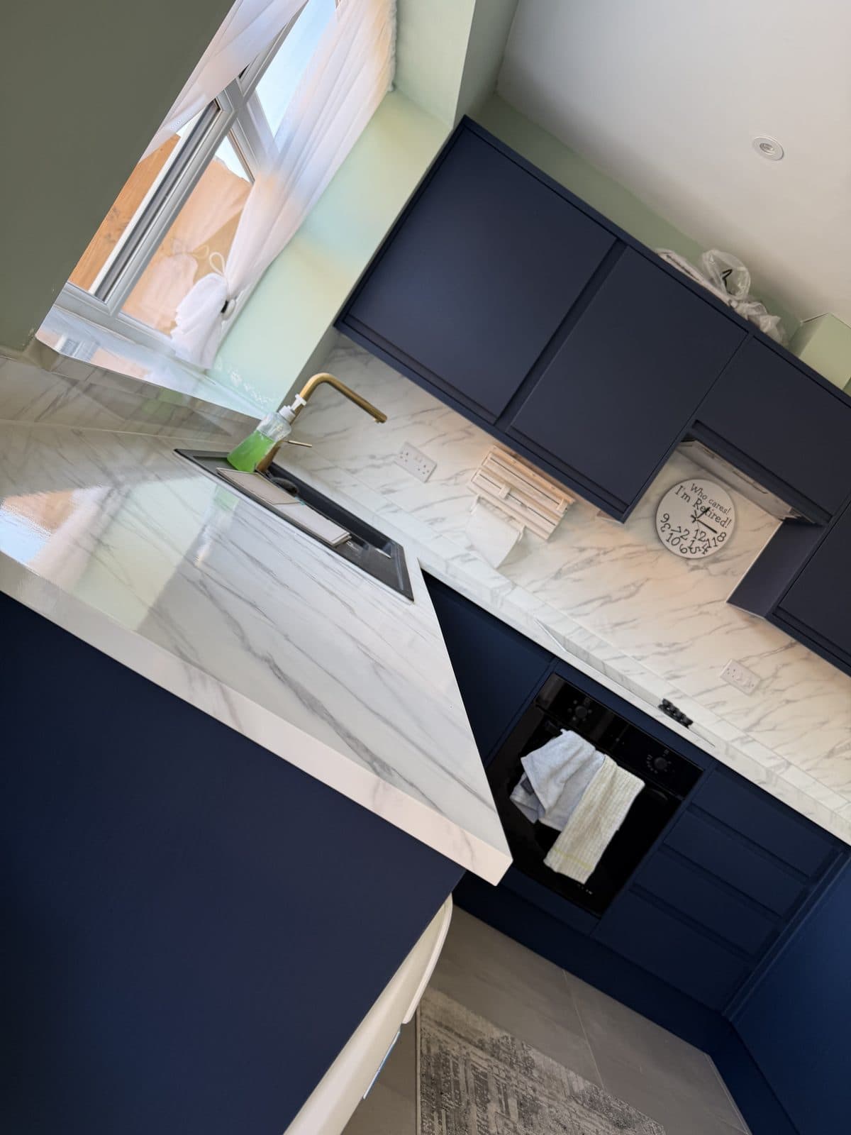 Navy wood-effect kitchen wrap Doncaster — worktop and oven area after