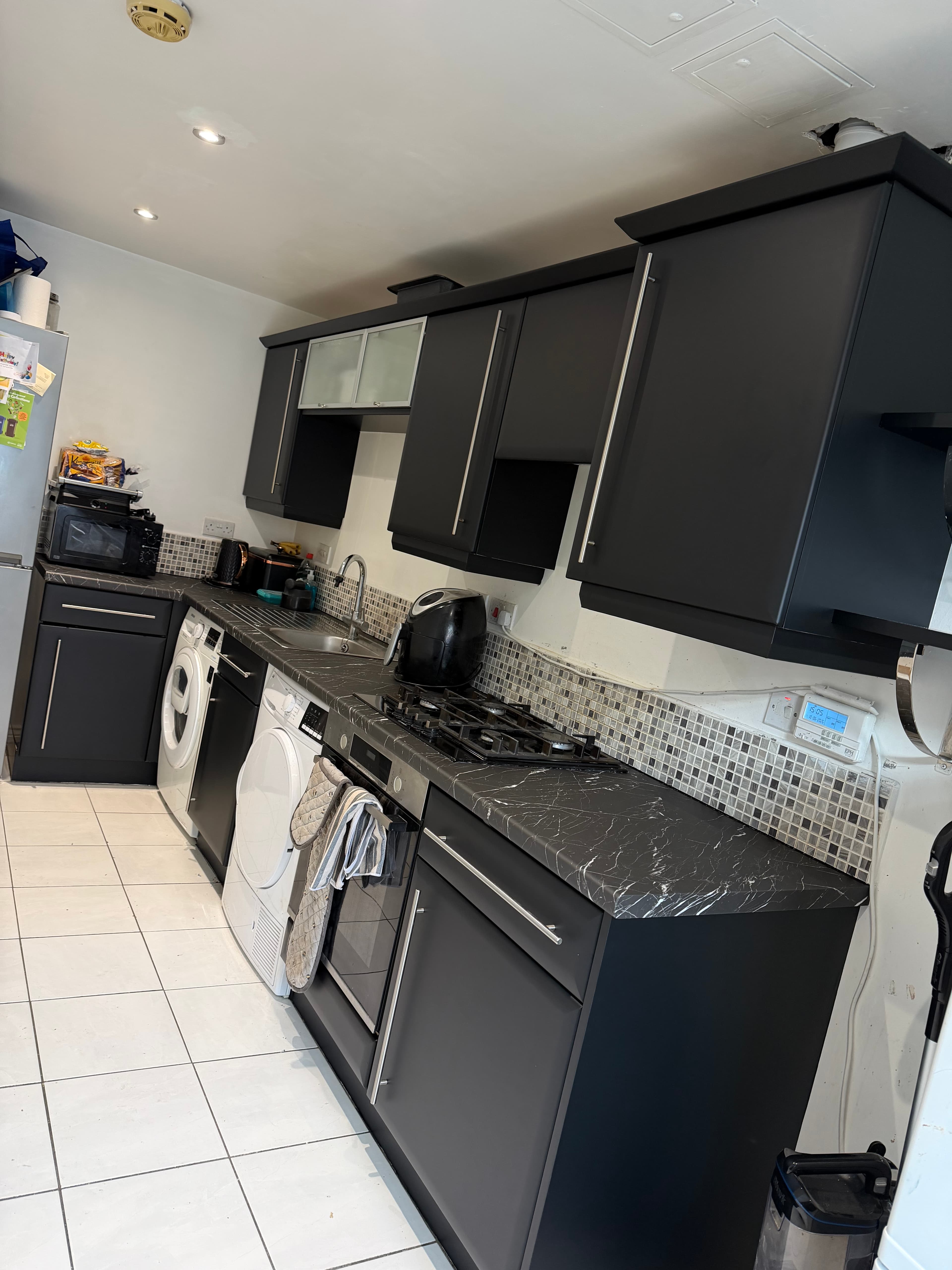 Black kitchen wrap Sheffield — full matte black kitchen after