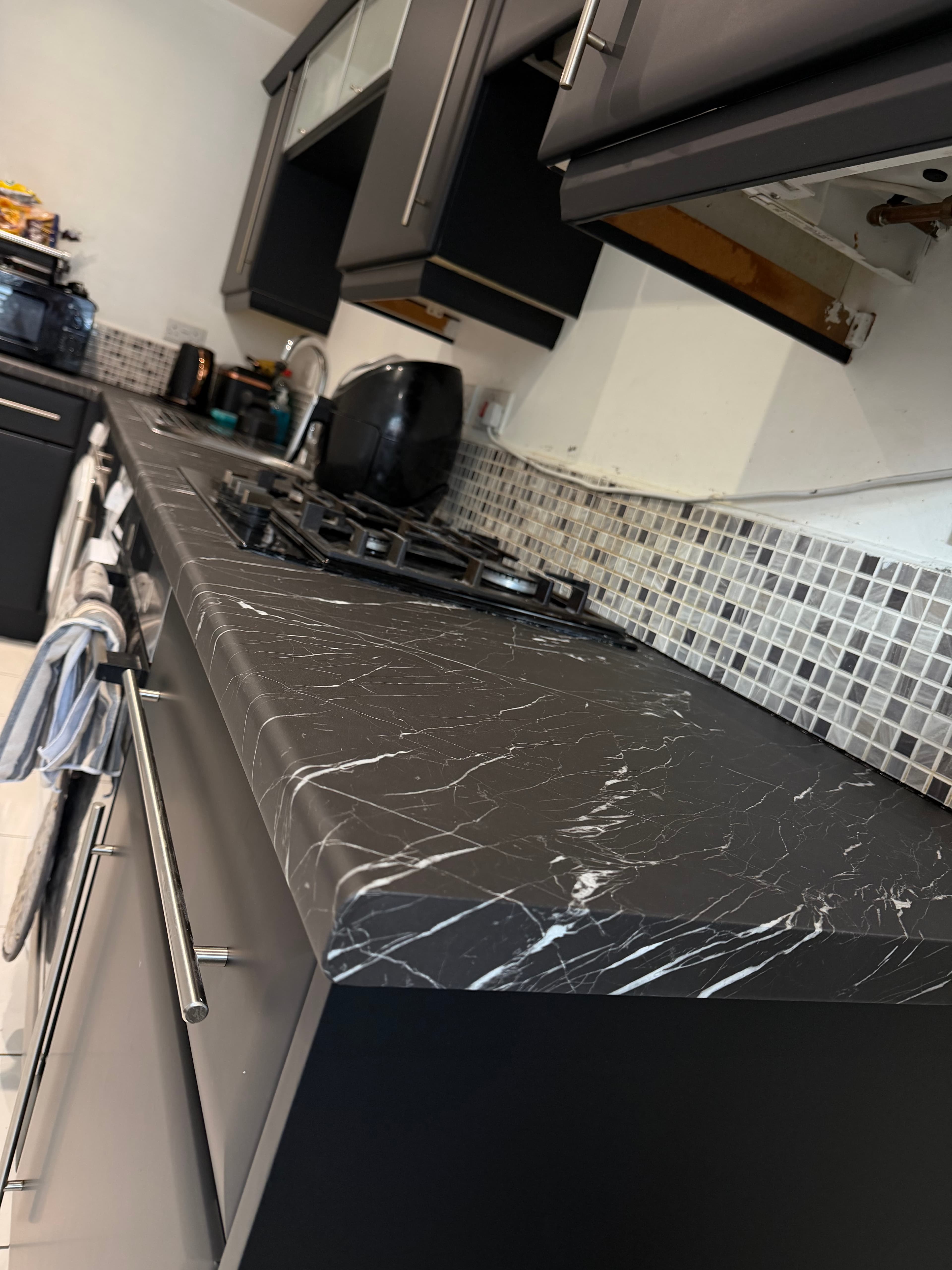 Black kitchen wrap Sheffield — black cabinets with marble worktop after