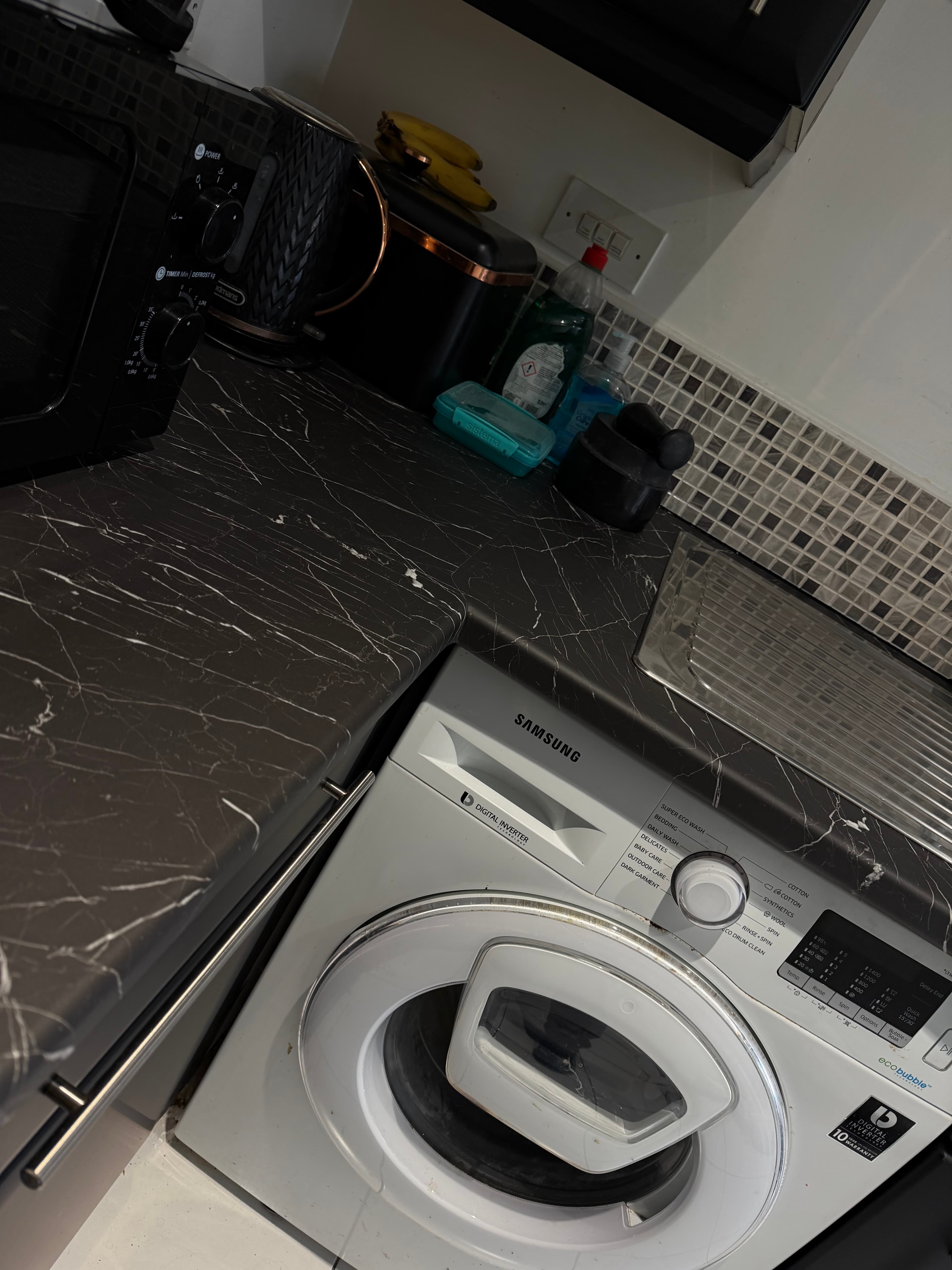 Black kitchen wrap Sheffield — cabinet and appliance detail after