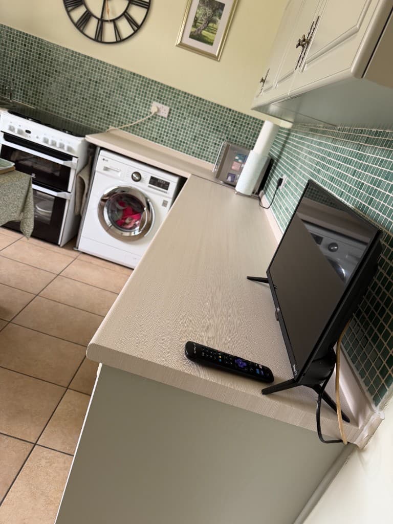 White wood-effect worktop wrap in Chesterfield — full counter run view