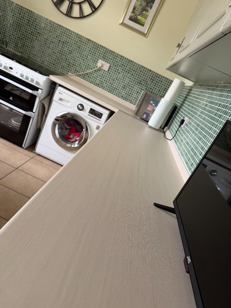 Kitchen worktop wrap in Chesterfield — completed white wood-effect installation